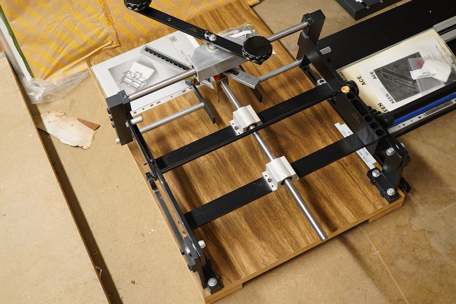 A collection of framing equipment to include Ademco heat press, C & H Bainbridge oval master mount cutter, Longridge baseboard, various mount and backing boards, tools, cutters, clamps and point drivers, many with instru